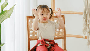 baby kids girl with neutral button kids top and red kids pajamas